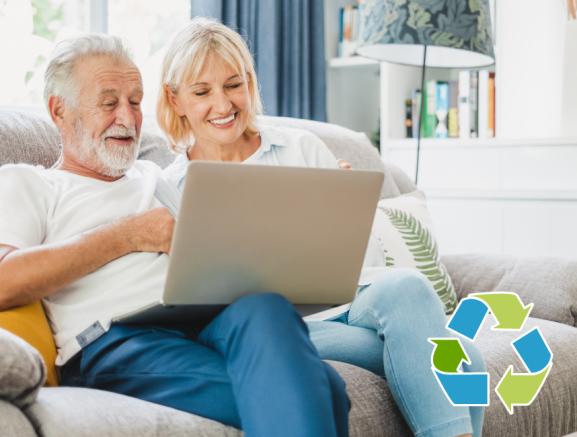 Couple senior using computer laptop on sofa at home